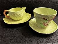 Set of CarltonWare cream pitcher, cup, and matching leaf-shaped saucers in pale green with Foxglove pattern