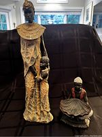 Wide shot of both figurines showing height difference and style.