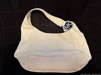 Full view of white Michael Kors leather hobo bag showing overall shape, texture, and strap.