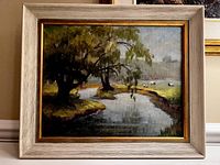 Full view of framed oil painting showing landscape with pond, trees, and sheep