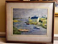 Full view of framed watercolour painting showing sailboats on water and background buildings under cloudy sky.