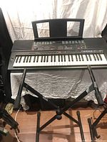 Yamaha PSR-500 keyboard on stand showing full length and keys with white backdrop.