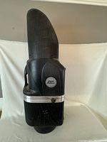 Front and side view of the black molded plastic golf club carrying case with 'Flight Master' badge.