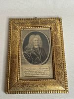 Full view of the framed antique etching showing ornate gold frame and oval portrait.