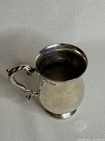 Full side-and-top view of the creamer showing its baluster shape and handle