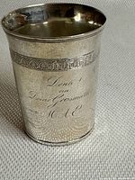 Angled full view of the cup showing overall shape and decoration