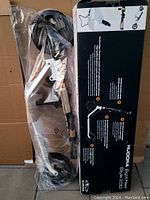 Hudora Big Wheel Style 230 scooter components in transparent plastic packaging, showing large wheels and metal frame components on top of a box.