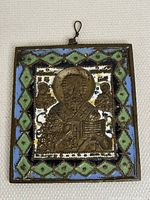 Full frontal photo of the brass Greek Orthodox icon with colorful enamel, showing the saint figure and background design.