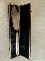 German silver serving utensil combining fork and knife in original case with black velvet lining