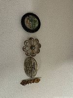Overview photo showing all four jewelry pieces on a light fabric background.