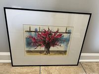 Full view of the framed art piece showing flowers in a vase by the window with bottles on the sill