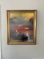 Framed oil painting showing a lone rower in a small boat on water under a foggy sky with sunset or sunrise hues, framed in gold.