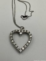 Pendant and chain on white background showing 14K hallmark on clasp