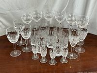 All 22 Waterford Colleen crystal glasses arranged on wood table
