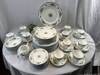 Full set arranged on table top against draped backdrop