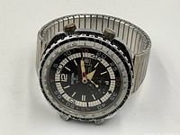 Front-angled view of watch face showing dial layout, hands, chronograph subdial and bezel condition.