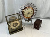 All three clocks displayed together on white backdrop without scale