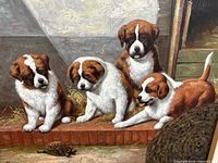 Close-up of four brown and white puppies seated by a brick ledge watching a small turtle.