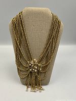 Necklace displayed on linen bust showing overall design and drape