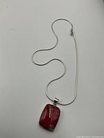 Full view of sterling silver snake chain necklace with attached bloodstone pendant.