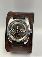 Front view of Timex watch on leather cuff band showing dial details