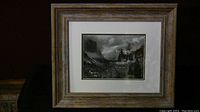 Framed image in rustic wooden frame showing the black and white landscape photo.