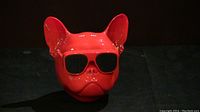 Front view of the red bulldog-shaped speaker with black sunglasses, glossy finish.