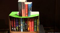 Box containing 16 mystery and crime novels with a mix of hardcover and paperback editions from various well-known authors.
