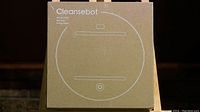 Image of the front of the Cleansebot box showing the circular design of the robot and the product name.