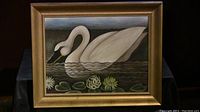 Photo showing framed original folk art painting of a swan in water with floral details.