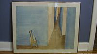 Framed lithograph print showing full artwork including abstract humanoid figure and perspective corridor in muted blue and brown tones.