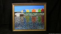 Full view of the framed acrylic painting showing colorful houses and water reflections.
