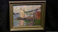 Full view of framed painting depicting a sailboat dock scene with buildings and landscape.