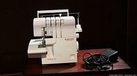 Front view of Singer overlocker with foot pedal