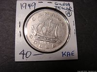 Reverse side of 1949 Canadian silver dollar showing Bluenose schooner and inscriptions