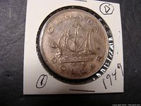 Reverse side of the 1949 Canadian silver dollar coin showing the sailing ship, date, and inscriptions.