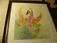 Framed watercolour painting showing butterfly on foxglove flowers.