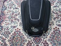 Front view of black Harley Davidson tank bag showing logo, zippers and handle.