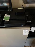 Apple TV, Sony Blu-ray player, Dell external DVD-RW on a surface