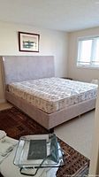 Overall view of king bed set including mattress, box spring, frame and headboard
