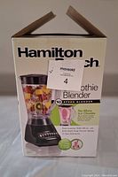 Front of the box showing product and Hamilton Beach branding with label indicating unused blender.