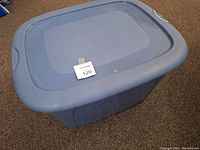 Top view of closed blue storage bin with lid showing overall condition.