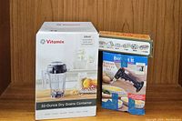 Photo showing boxed Vitamix 32-Ounce Dry Grains Container, Crème Brûlée Set, and Sushi Kit together
