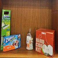 Photo showing all four items: Swiffer kit, Ziploc Big Bags box, gift basket, and Hard Cider Kit