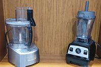 Cuisinart food processor and Vitamix blender side by side on shelf