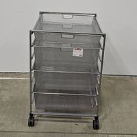 Front view of Elfa 4-drawer mesh storage cart on wheels showing all drawers in place with visible brand tag on second drawer.