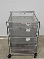 Front view of the 4-drawer Elfa mesh cart showing mesh drawers and metal frame with caster wheels