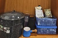 Granite-Ware canner with lid, two box graters, blue enamel butter warmer, two plastic boxes with cookie cutters