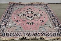 Full view of the pink Turkish style area rug showing the entire rug with medallion and border details.