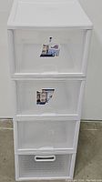Stack of 4 clear plastic stacking drawers, three standard and one bottom with perforated handle.